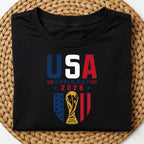 American soccer fan graphic tee featuring USA World Cup 2026 typography and FIFA trophy illustration