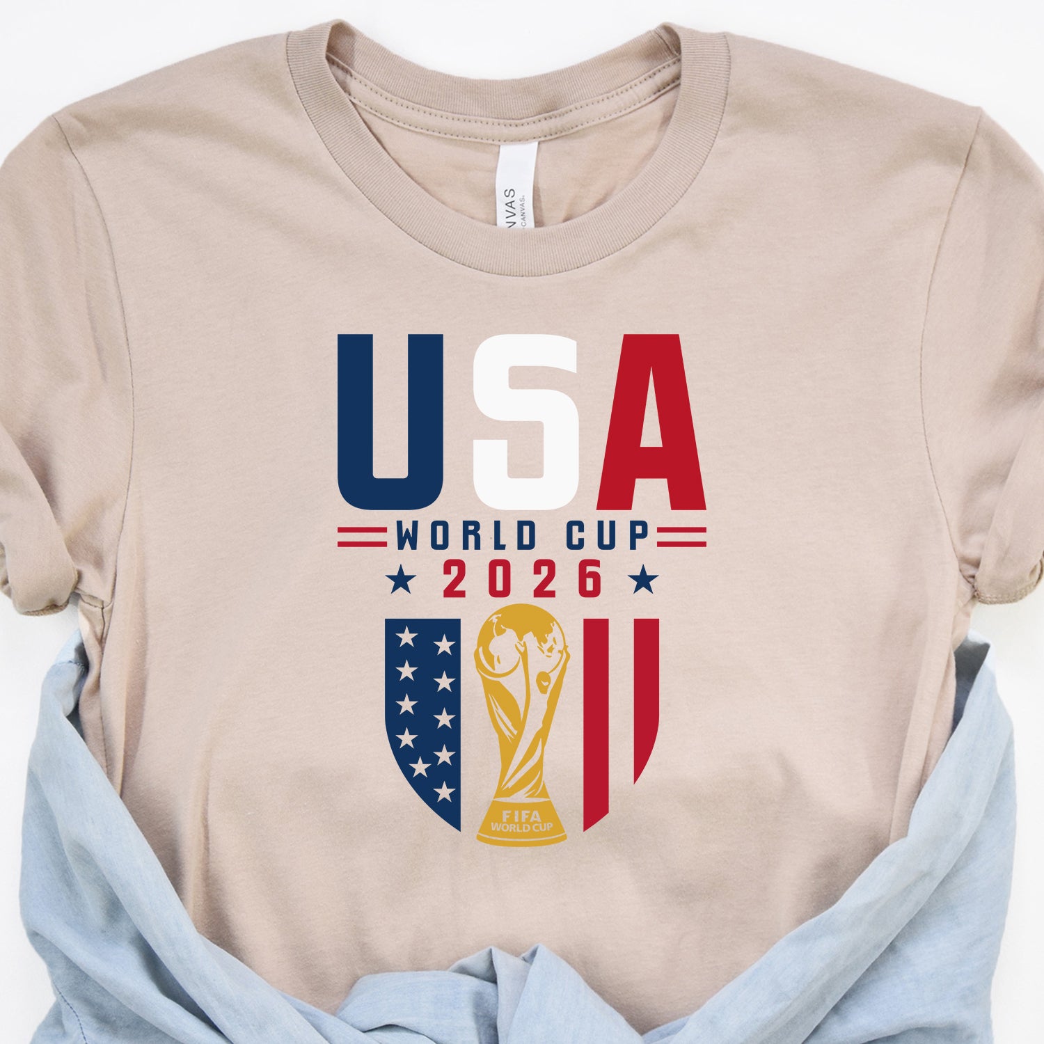 2026 FIFA World Cup USA themed graphic t-shirt in white with bold red and blue soccer fan print